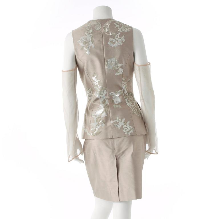 GIANFRANCO FERRÉ, a beige three-piece ensemble consisting of vest , trousers and skirt.