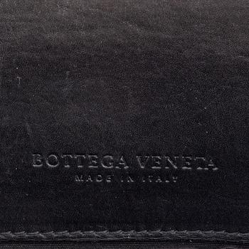 Bottega Veneta, a black leather intrecciato briefcase.