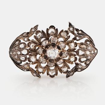 998. A silver and 18K gold brooch set with rose-cut diamonds.