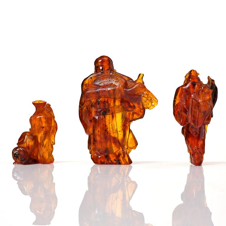 A group of three amber scultpures, late Qing dynasty/early 20th Century.