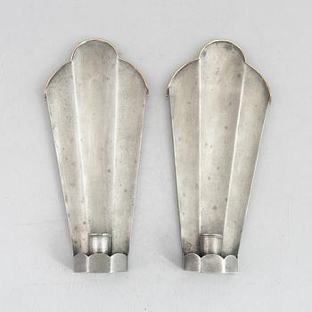 Nils Fougstedt, a pair of pewter and brass wall sconces, model "A 146", Svenskt Tenn, Stockholm 1926.