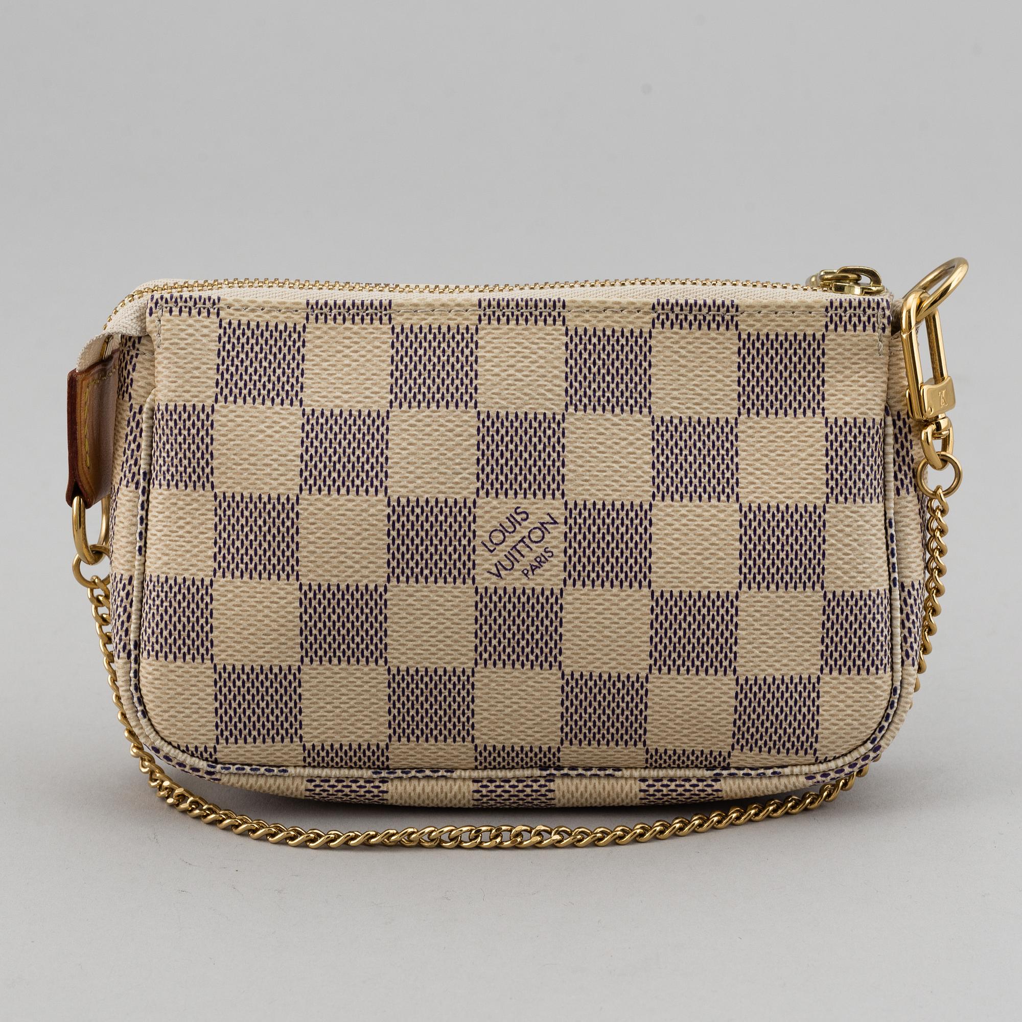 LOUIS VUITTON, A 'Mini Pochette Accessoires' and a shoulder strap.