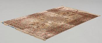 A RUG. A semi-antique silk figural souf (in relief), probably India. 208 x 128,5 cm (as well as two cm flat weave at.