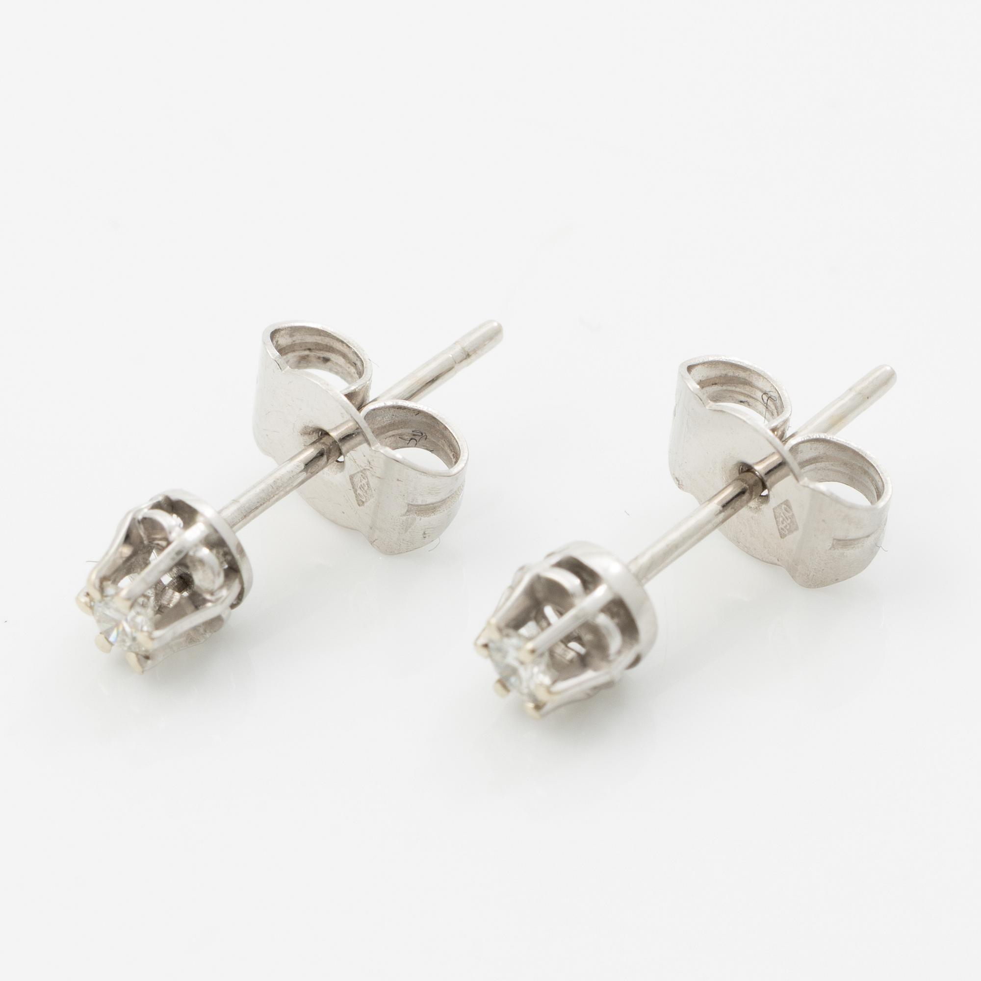 A pair of 18K white gold earrings with round brilliant-cut diamonds.