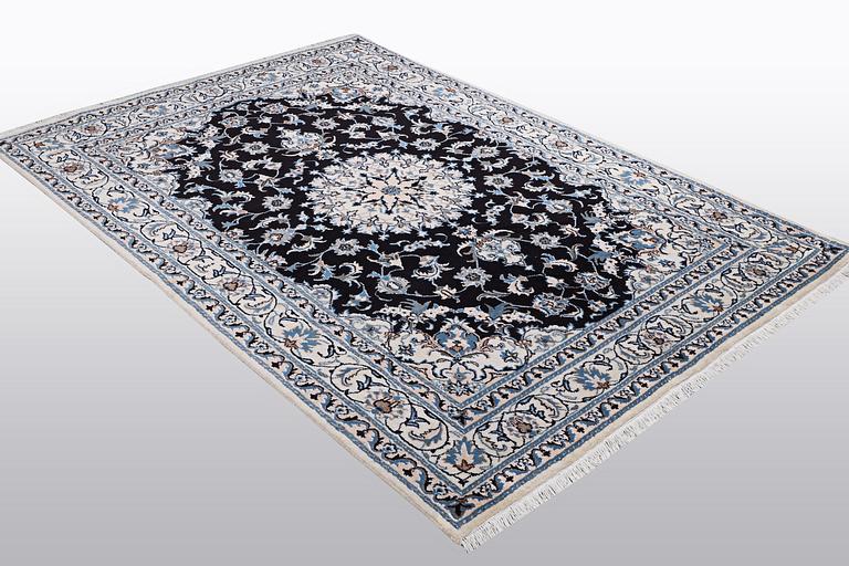 A rug, Nain, part silk, ca 242 x 167 cm.
