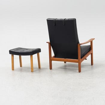 A 1970's teak and pvc coated fabric armchair and stool.