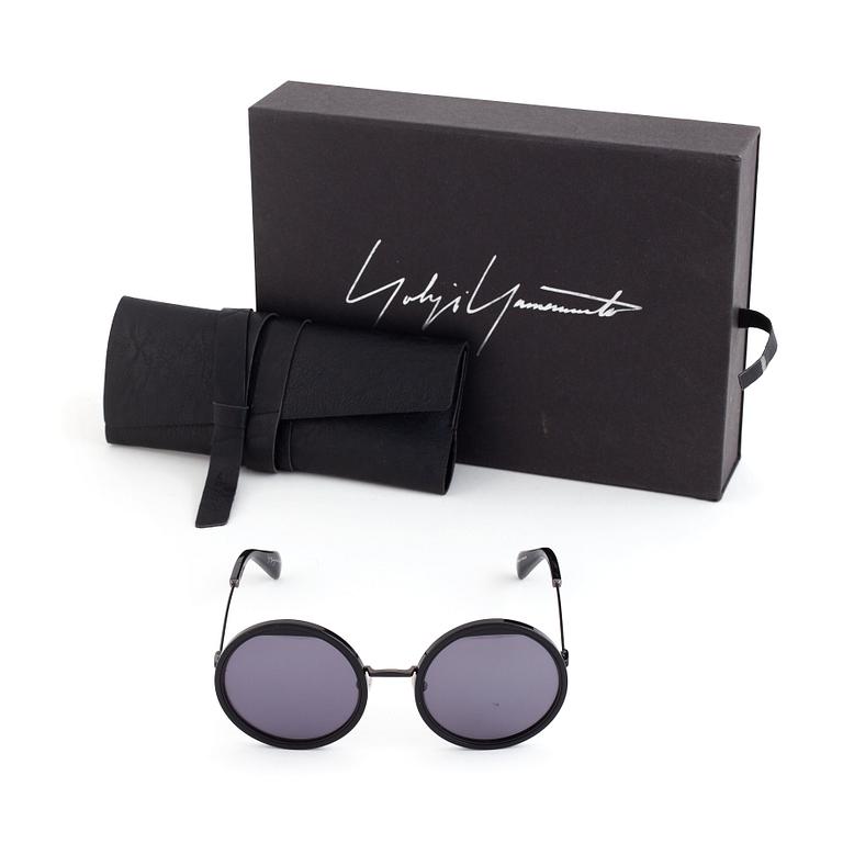 A pair of Yohji Yamamoto sunglasses.