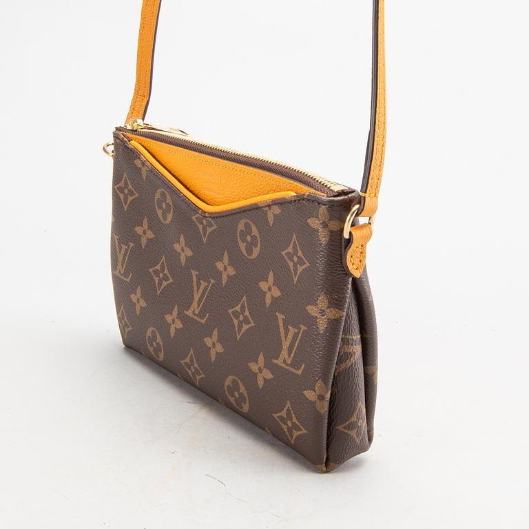 A Louis Vuitton Pallas clutch.