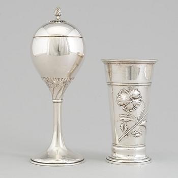 An Art Nouveau parcel-gilt lidded cup and beaker, maker's mark CG Hallberg, Stockholm 1913 and 1900.