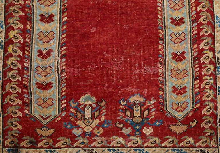 A RUG, an antique Anatolia, probably Gördes, a prayer rug, ca 177 x 124,5 cm (as well as flat weave at the ends 3 and 1.