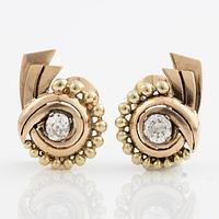 A pair of earrings in 14K gold set with old-cut diamonds.