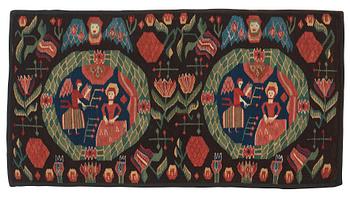 CARRIAGE CUSHION. "The Annunciation". Tapestry weave. 52 x 96,5 cm. Scania, Sweden, first half of the 19th century.