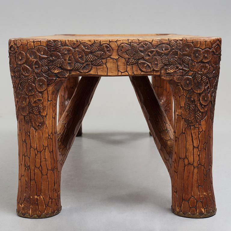 Gustaf Fjaestad, an Art Nouveau carved pine table, Arvika Sweden 1914, a double to the table in the Thiel Collection,