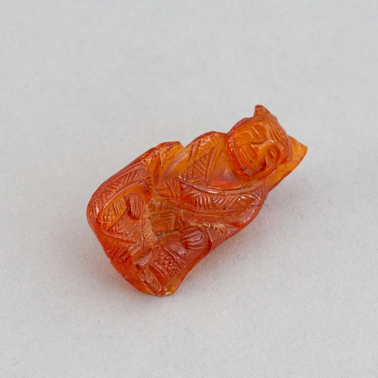 A group of amber objects, China, 20th Century. (14 small pieces).