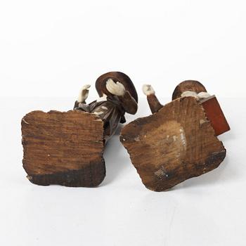 A pair of German carved bone and limewood figures by a follower of Simon Troger, early 18th century.