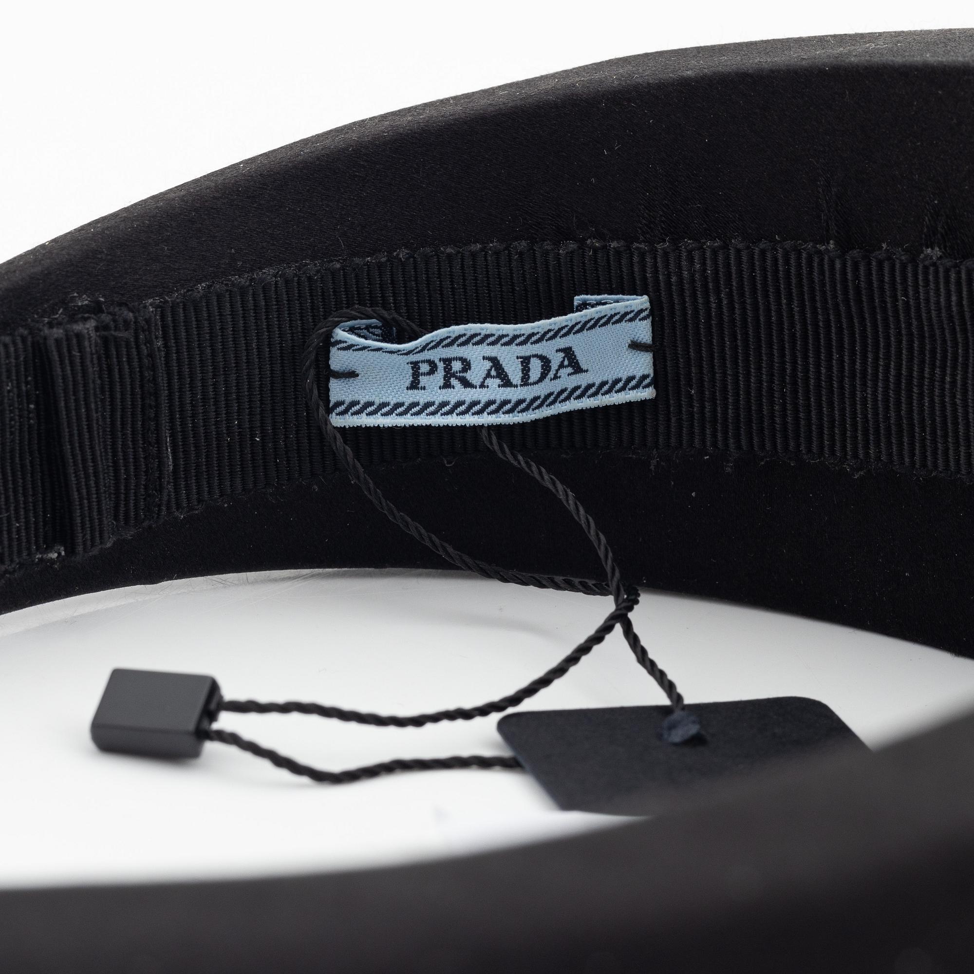 Prada, a black silk hair accessory.