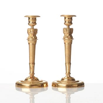 A pair of French Empire early 19th century gilt bronze candlesticks.