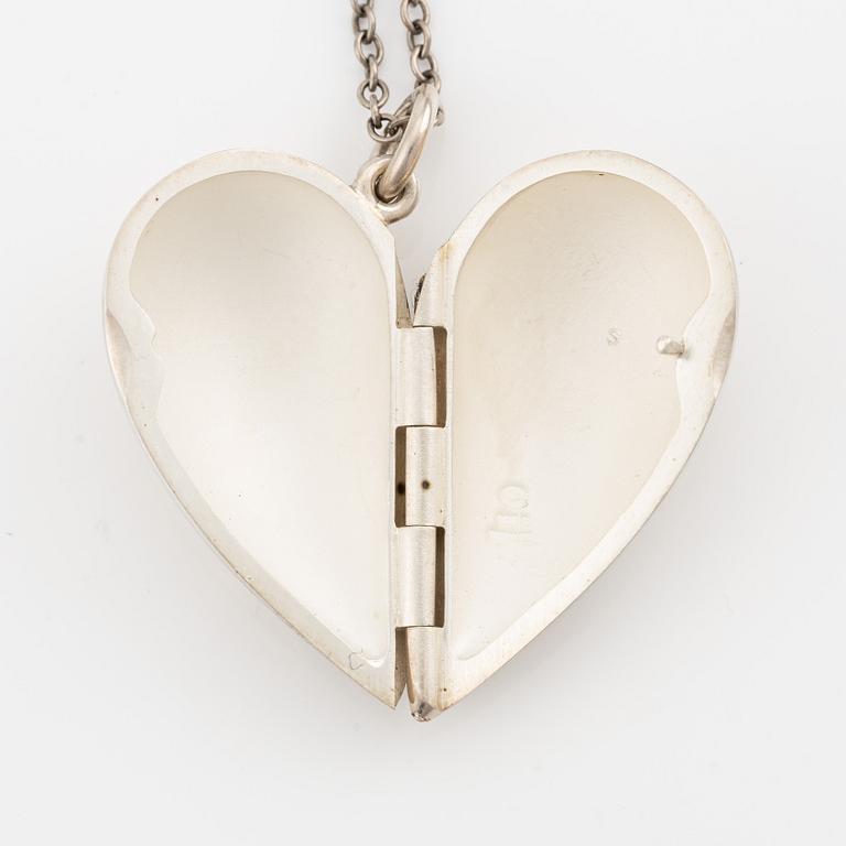 Georg Jensen, charm with chain and a pair of earrings, sterling silver.