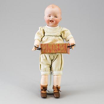 A bisque headed boy doll by Heubach, Germany, 1910s.