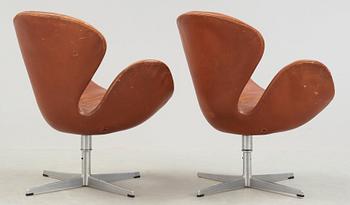 A pair of Arne Jacobsen brown leather 'Swan' chairs, Fritz Hansen, Denmark 1972.