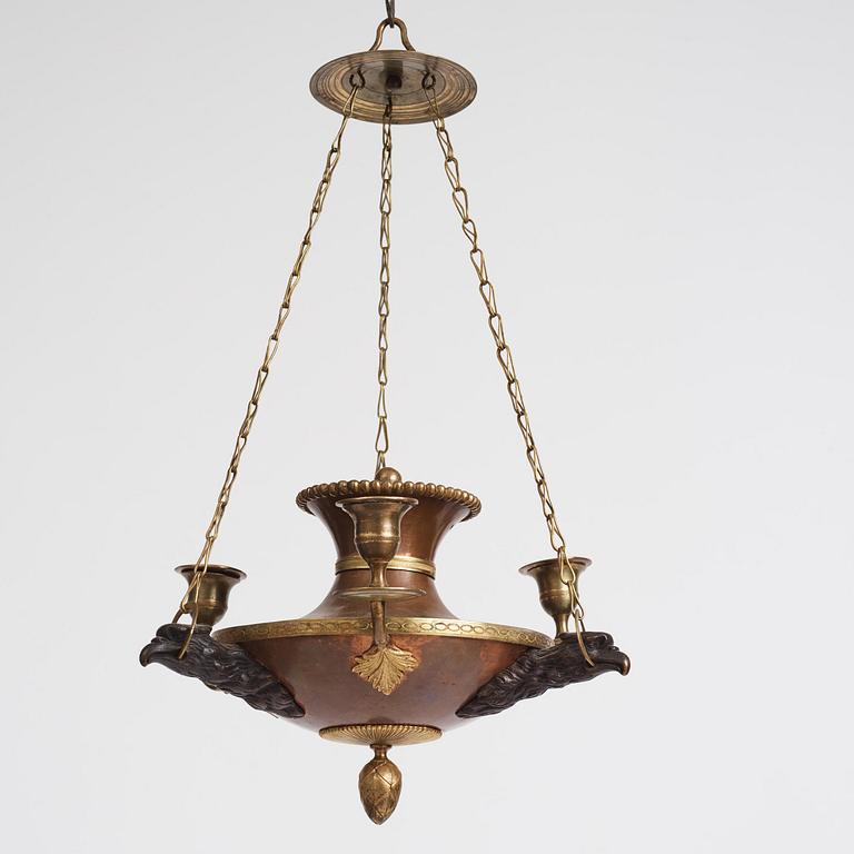 A Swedish patinated bronze and copper three-light chandelier, early 19th century.