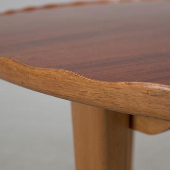 A mid 20th century coffee table in beech and veneered with mahogany.