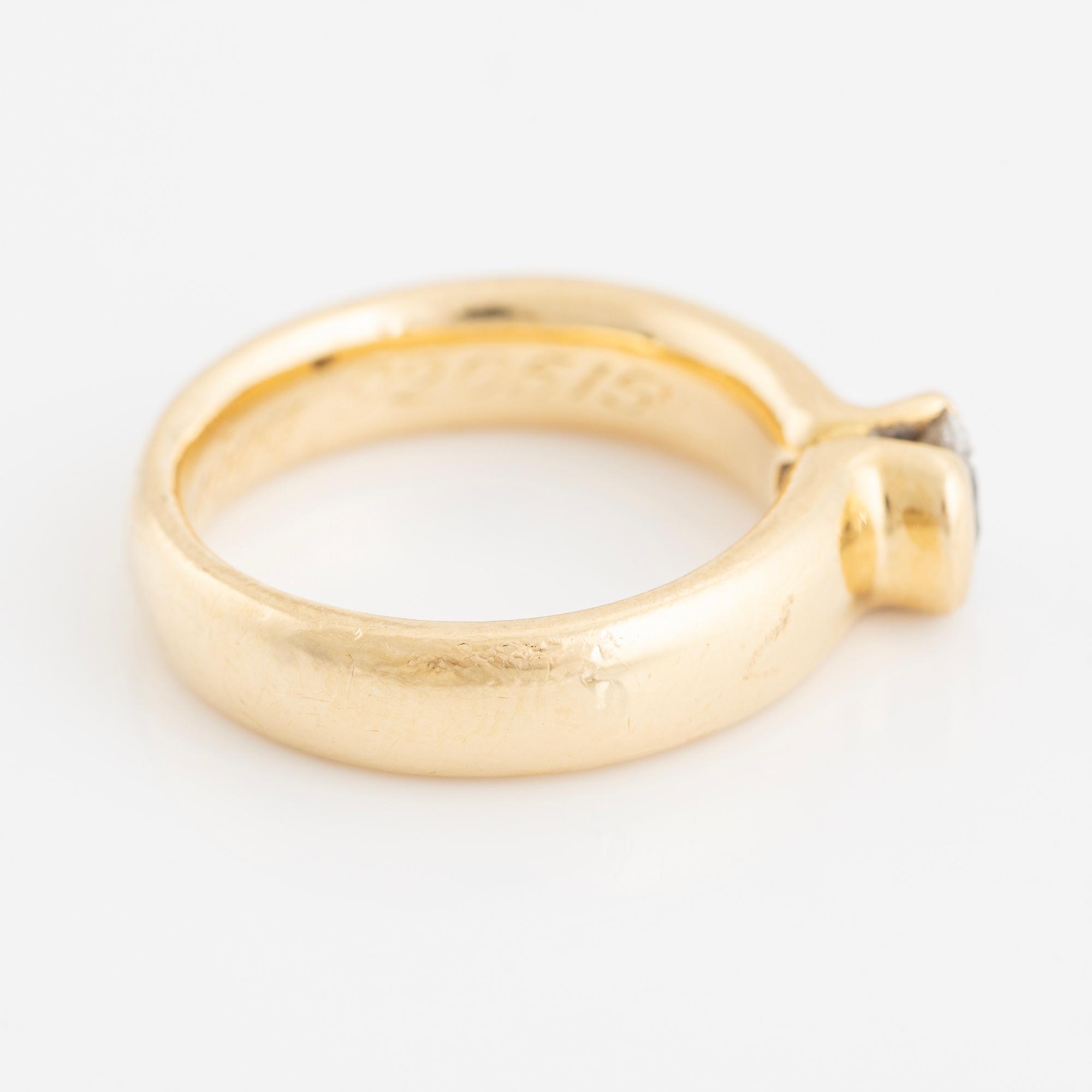 Gold ring with brilliant-cut diamond.