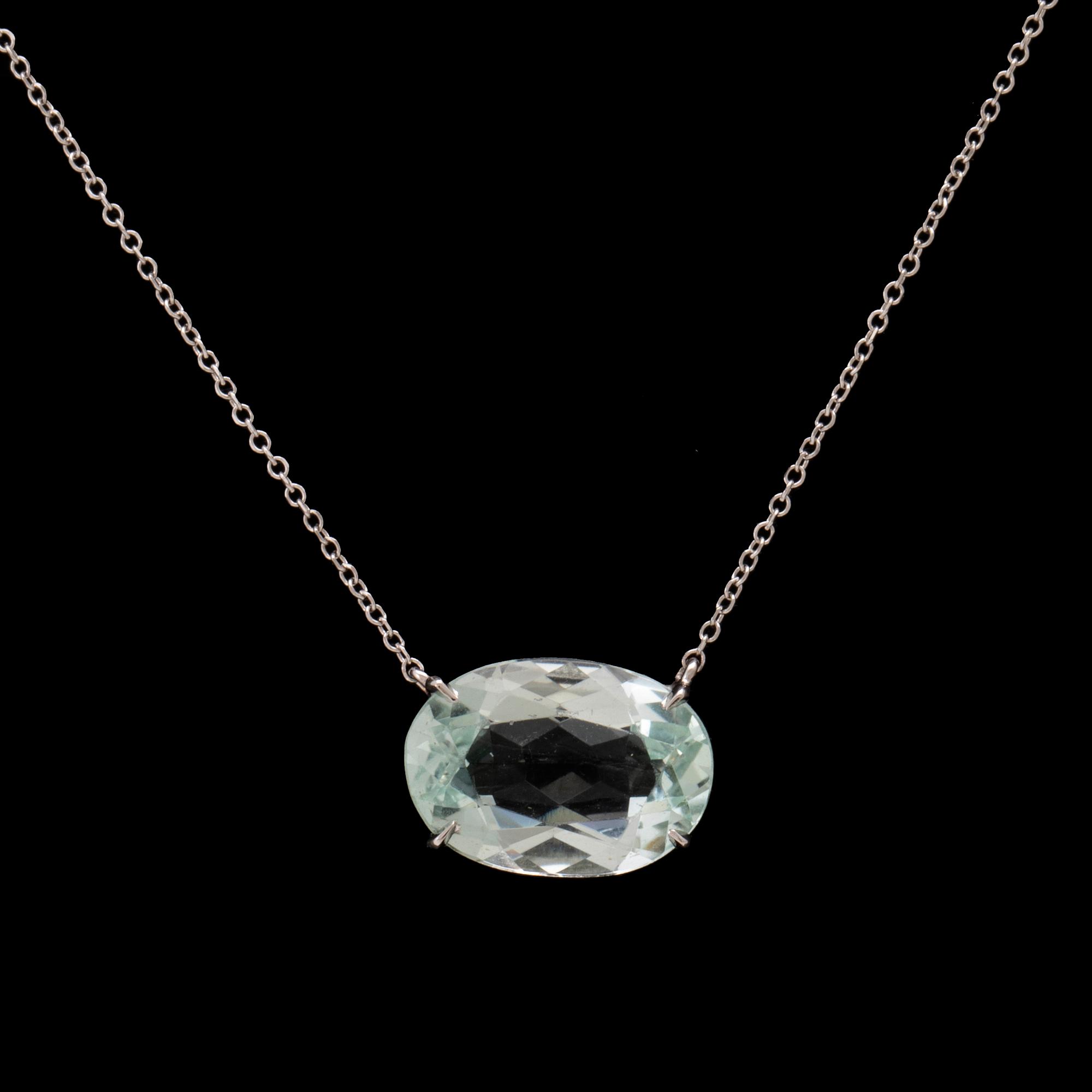 An 18K white gold necklace with an oval faceted aquamarine.