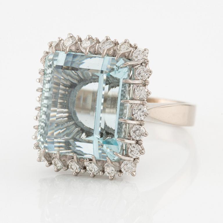 An 18K white gold Engelbert ring set with a aquamarine and round brilliant-cut diamonds.