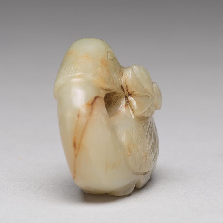 A Chinese nephrite figure of a duck with a lotus bud.