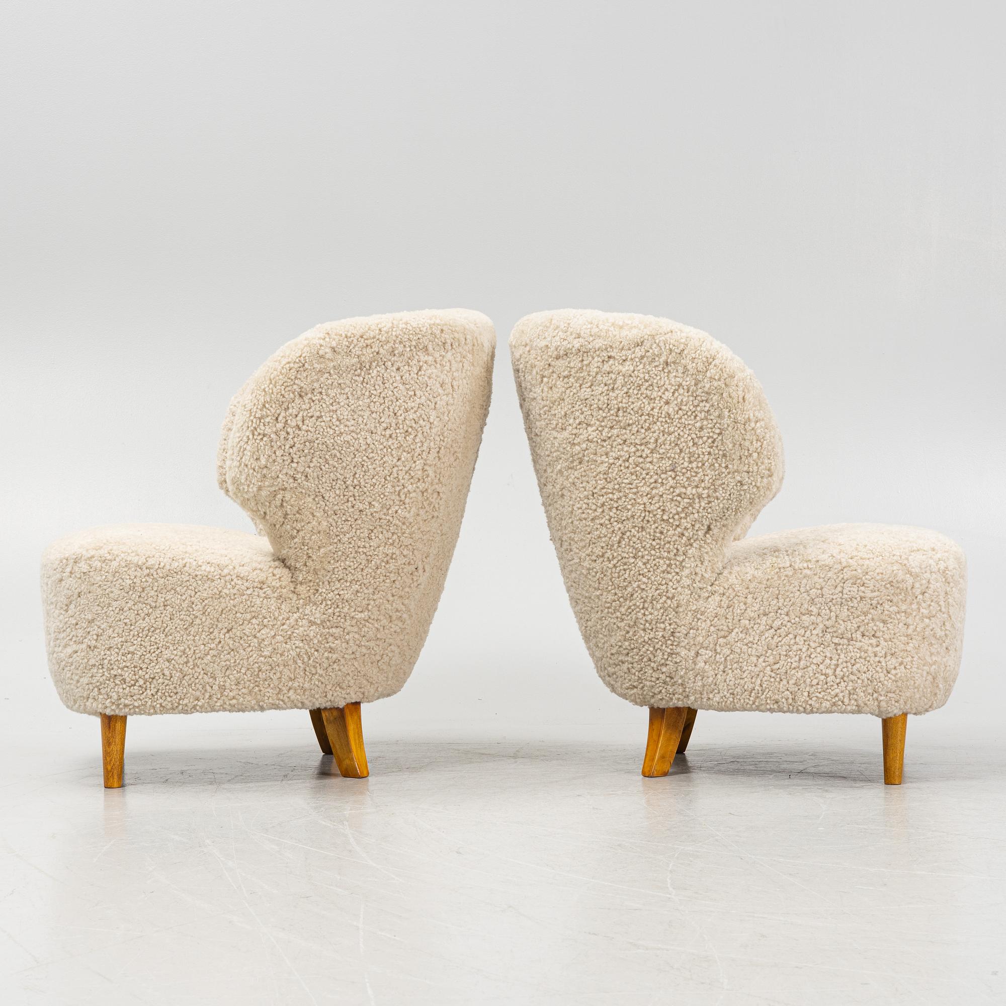 A pair of Scandinavian Modern 1940s cheepskin armchairs.