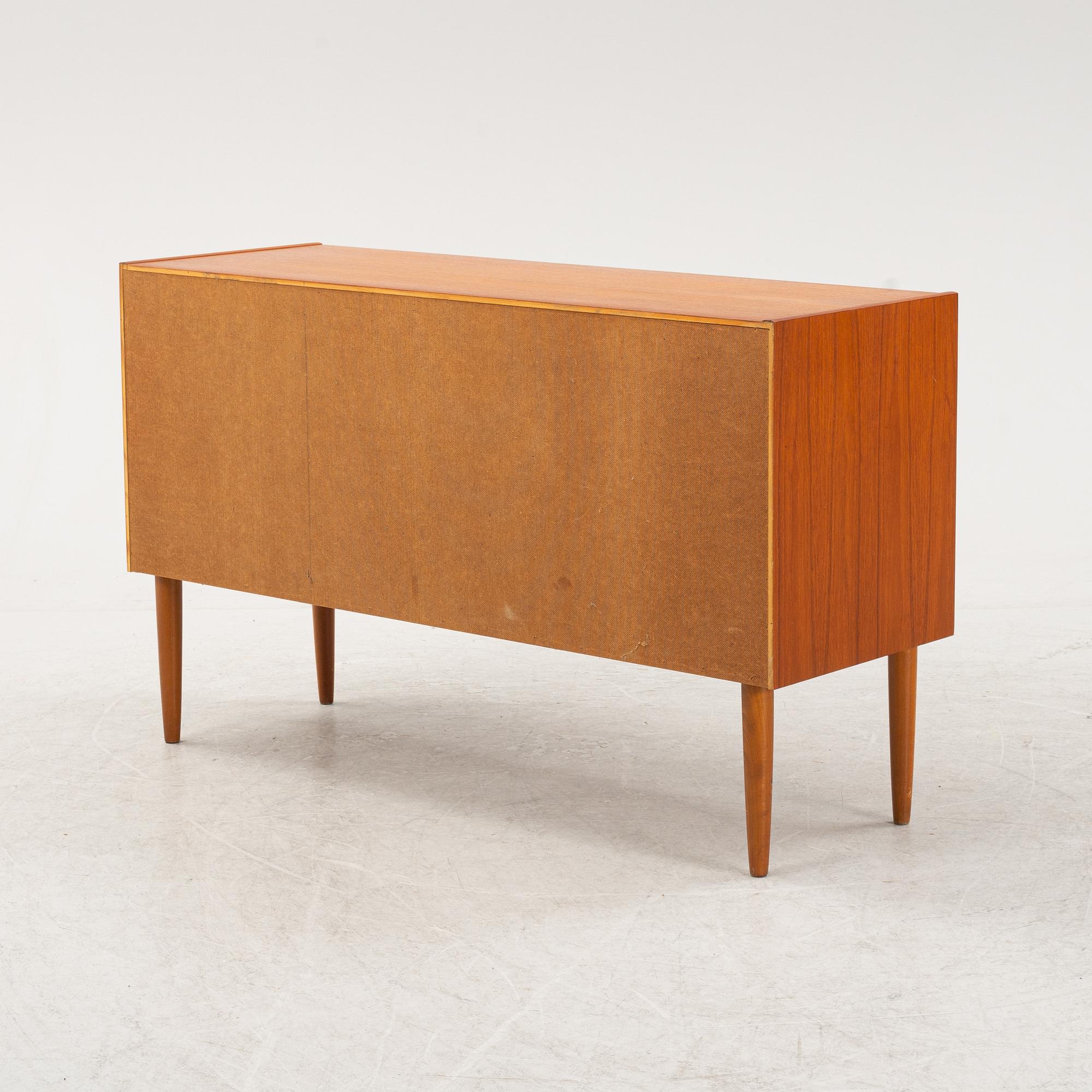 A 1950's teak veneered sideboard.