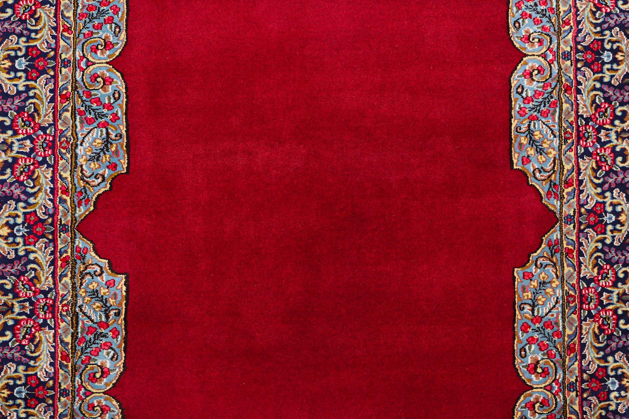An old Kerman carpet, signed, c. 290 x 208 cm.