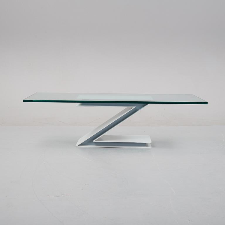 A grey lacquered metal and glass sofa table.