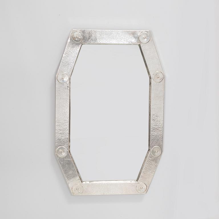 A mirror with silver decor by Palmgrenska Samskolan in Stockholm year 1971.