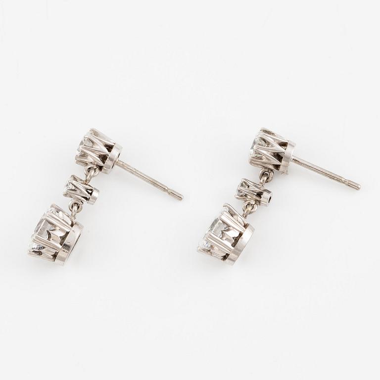 A pair earrings in 18K white gold set with round and oval brilliant-cut diamonds.