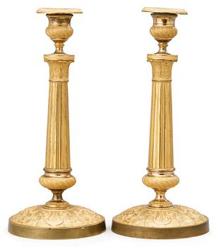562. A pair of French Empire early 19th century candlesticks.