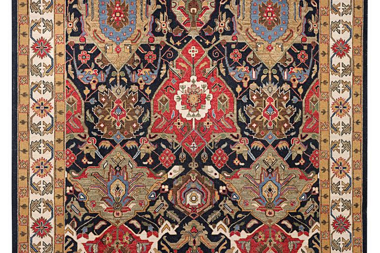 An oriental carpet with Mamluk design, c. 364 x 276 cm.