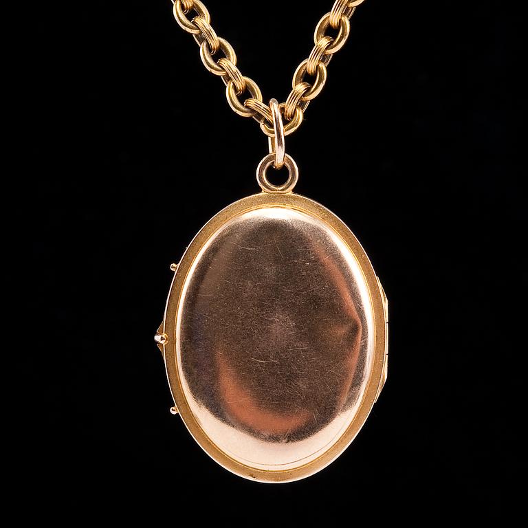 MEDALJONG, flerfärgsguld, rubiner, cabochonslipad safir 4,5 x 3,5 mm.