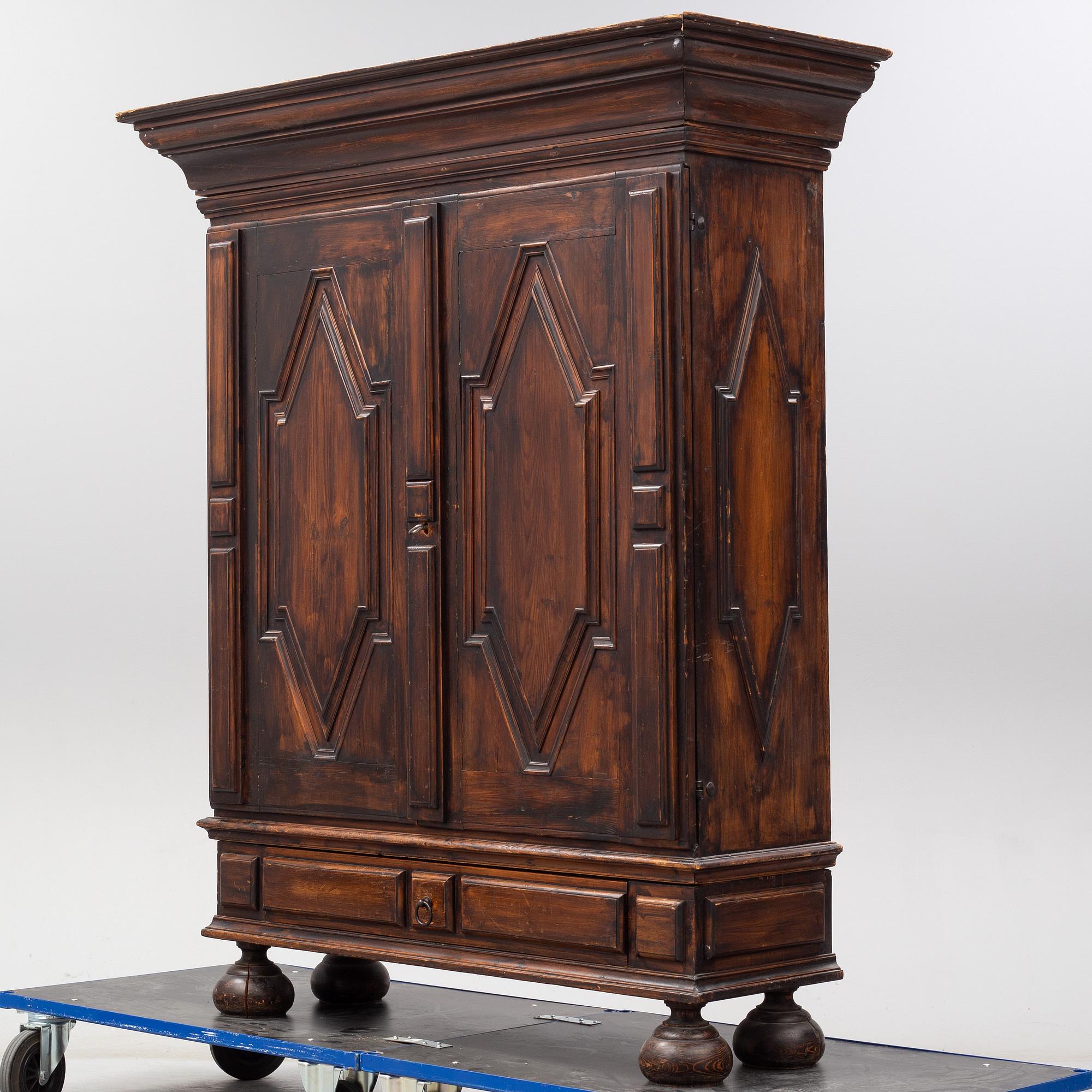 A first half of the 18th Century Baroque stained pine cabinet.