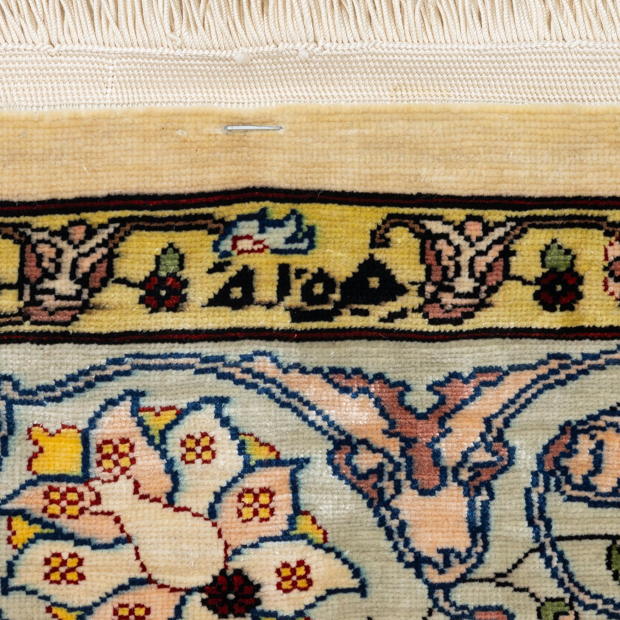 A silk Hereke rug, Turkey, approx. 82 x 58 cm.