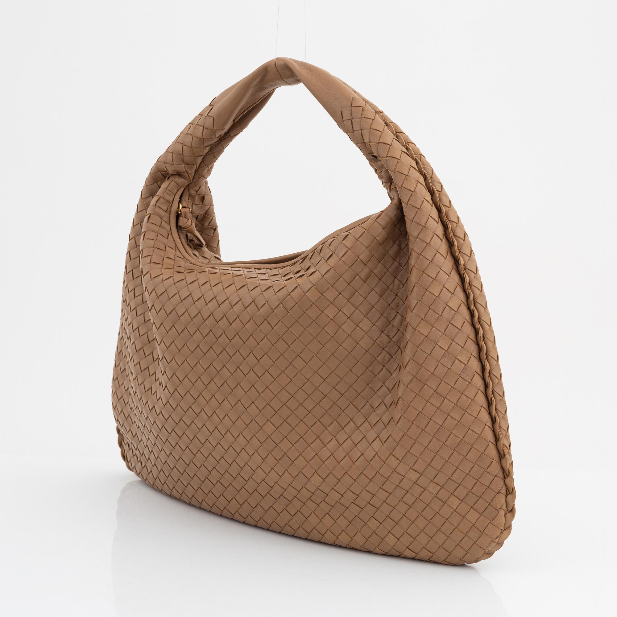Bottega Veneta, a beige intrecciato leather bag.