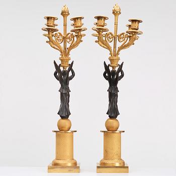 A pair of Empire four light candelabra.