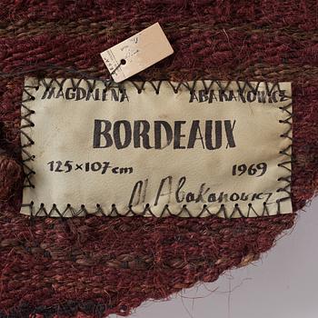 Magdalena Abakanowicz, a tapestry, "Bordeaux", flat weave, ca 125 x 107 cm, signed and dated 1969 verso.