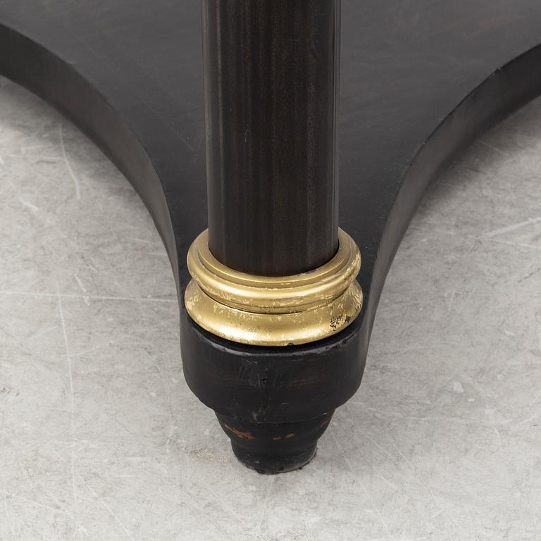 A contemporary empire style sheet metal center table.