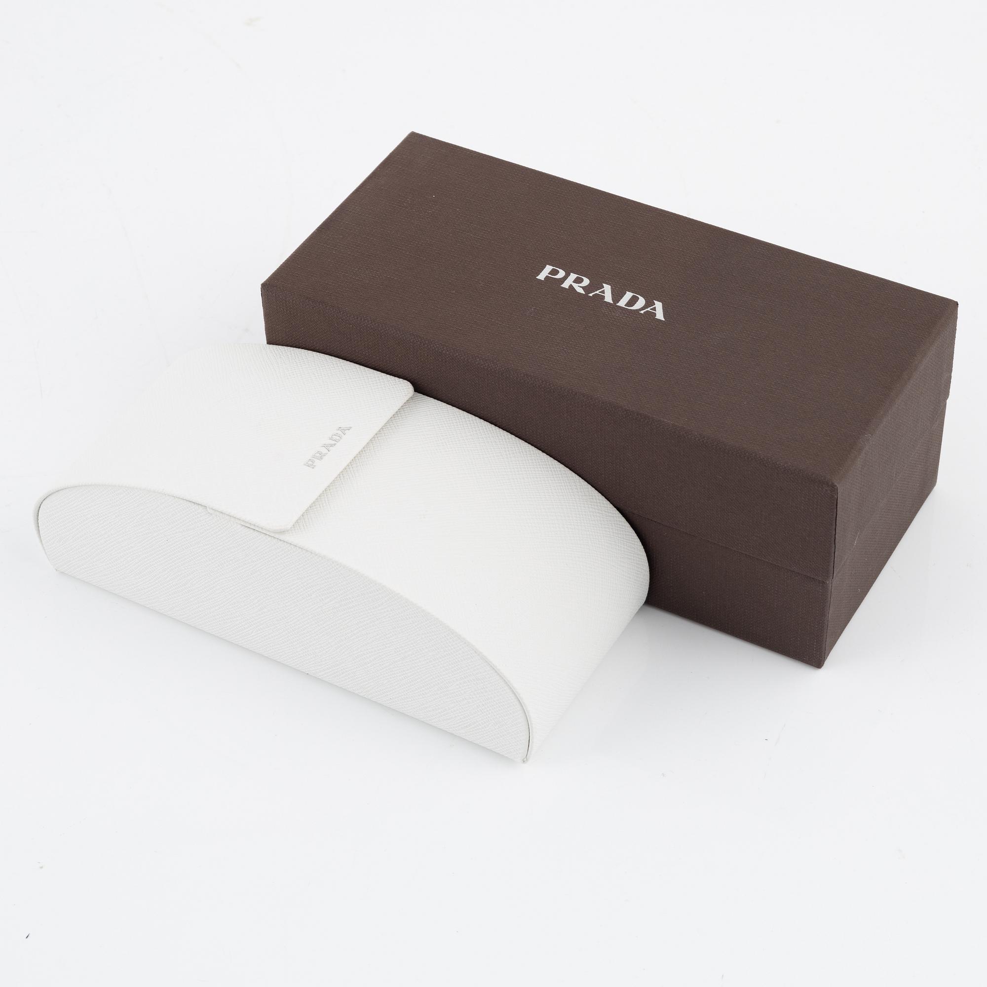 Prada, a pair of wood and leather sunglasses.