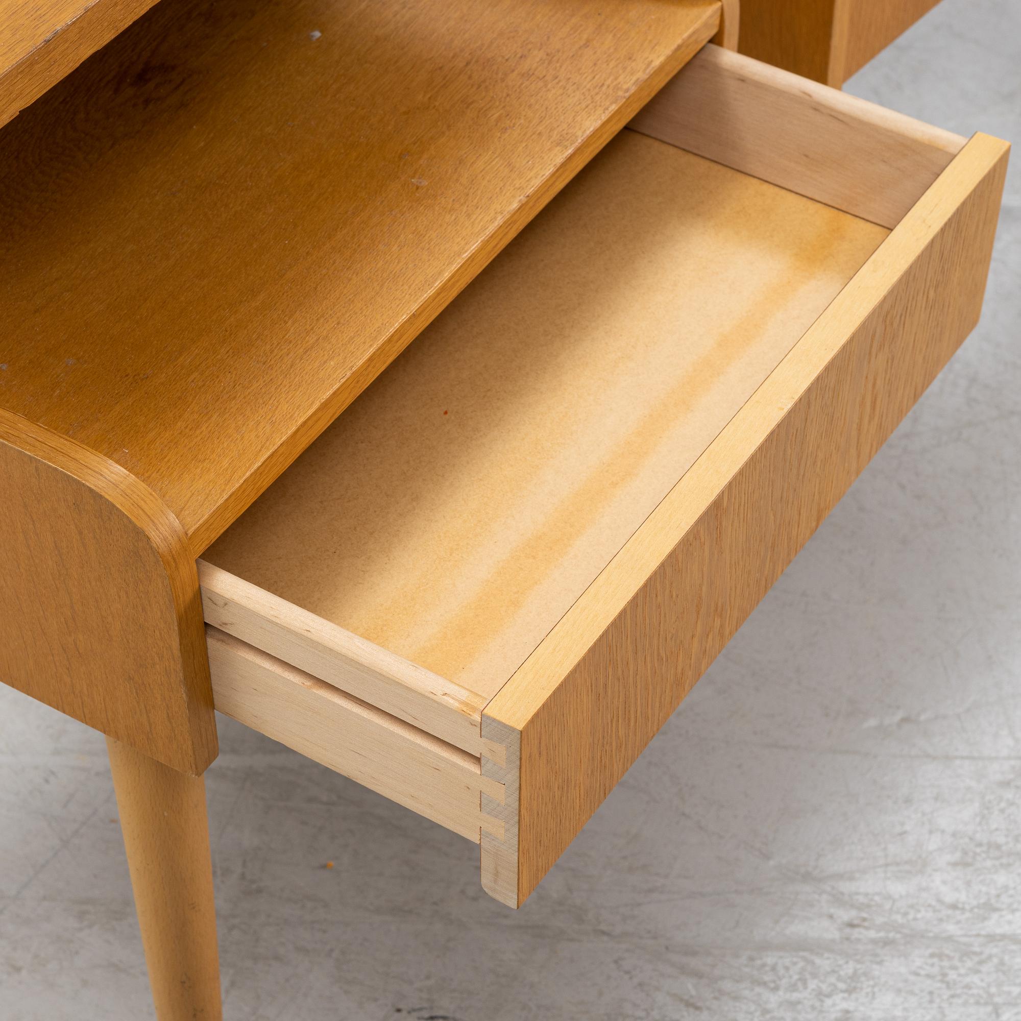 A pair of oak veneered bedside tables, mid 20th Century.