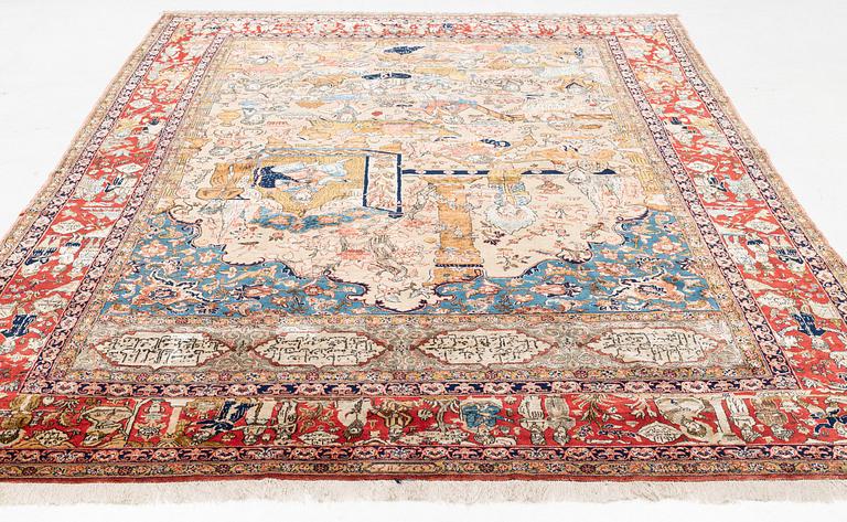 A signed semi-antique pictoral part silk Qum carpet, c. 341 x 224 cm.