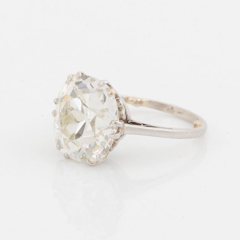 A platinum ring set with a cushion-formed old-cut diamond.
