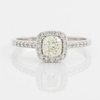 Cushion shaped diamond and brilliant cut diamond ring.